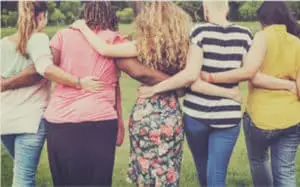 Women walking arm in arm
