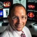 Dr. Gary Ulaner in front of screening images