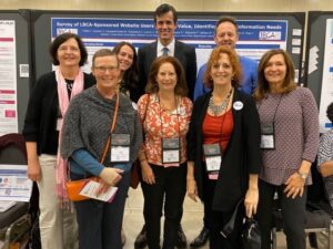 Lobular breast cancer patient advocates and researchers in front of scientific poster