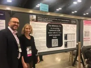 Dr. Jason Mouabbie and Dr. Deb Mueller in front of poster at SABCS.