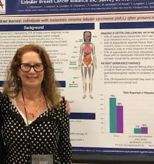 Woman in front of LBCA scientific poster.