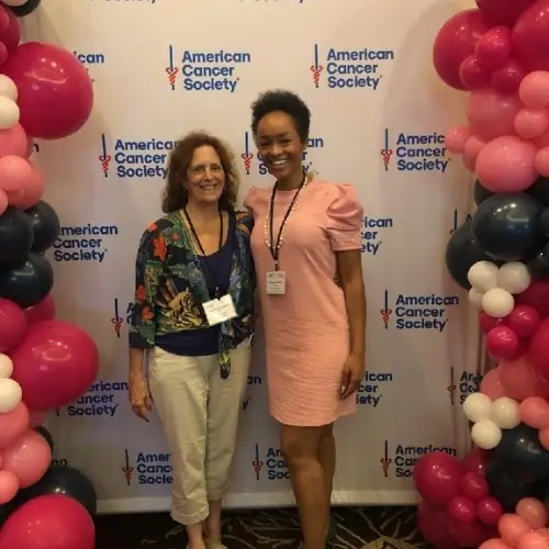 Women in front of ACS sign with balloons