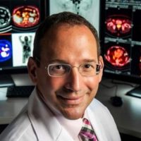 Dr. Gary Ulaner in front of screening images